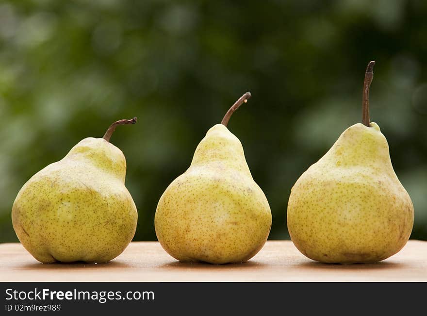 Fresh pears against green background