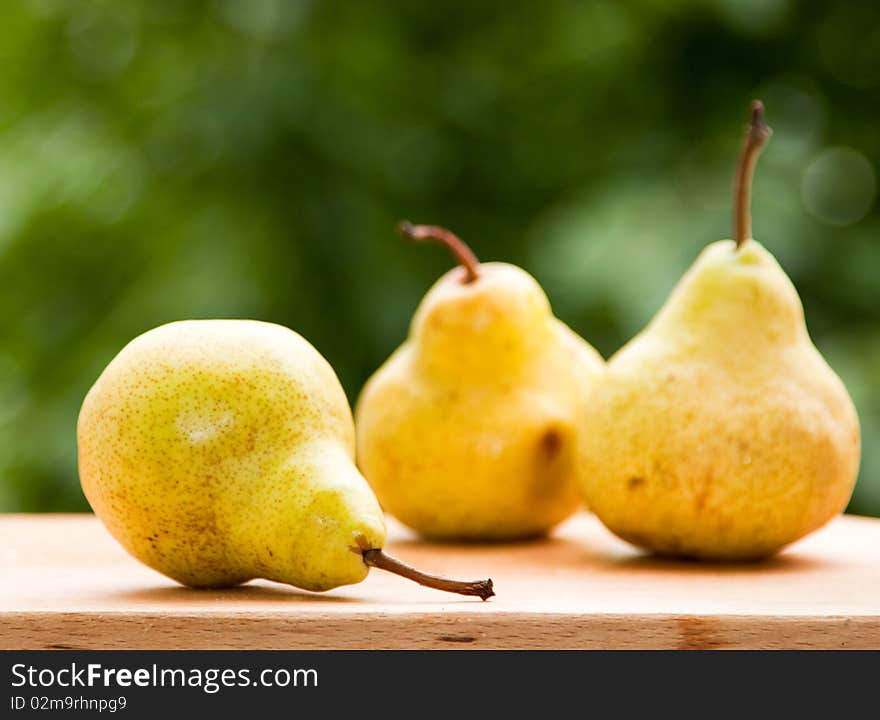 Fresh pears against green background