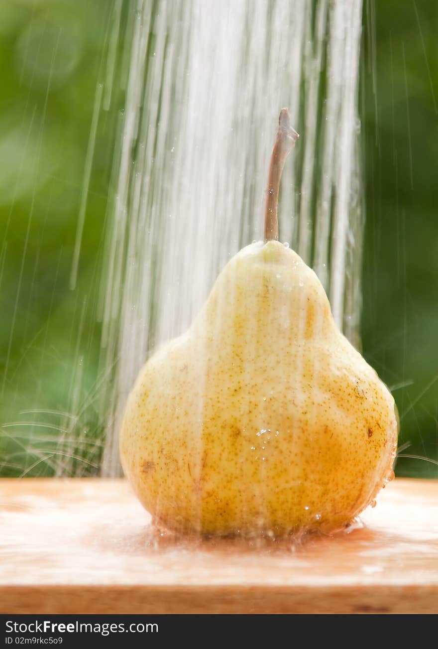 Pear washed under flowing water. Pear washed under flowing water