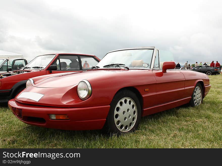 Classic red car on the grass. Classic red car on the grass