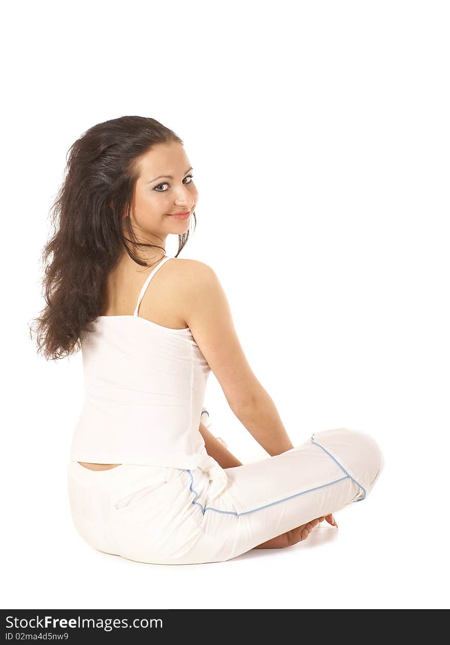 A young brunette is sitting on the floor