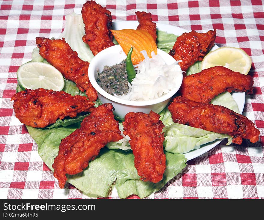 Tadoori fish in white plate with sauce and salad. Tadoori fish in white plate with sauce and salad