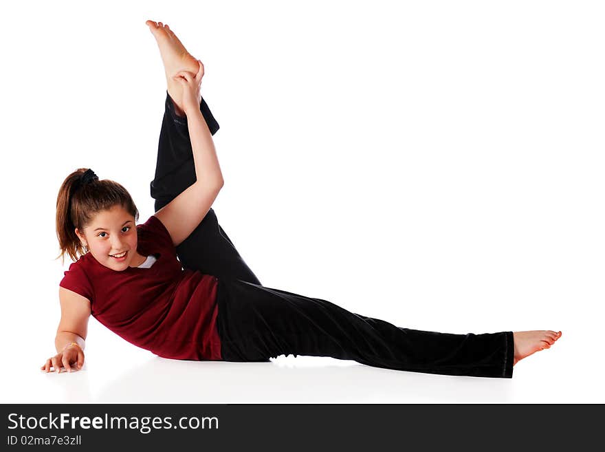 A reclining happy preteen lifting one leg far over her head.  Isolated on white. A reclining happy preteen lifting one leg far over her head.  Isolated on white.