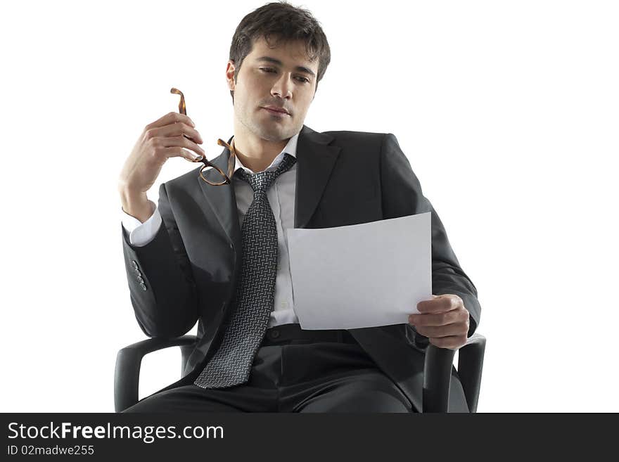 Businessman analyzing document, white background