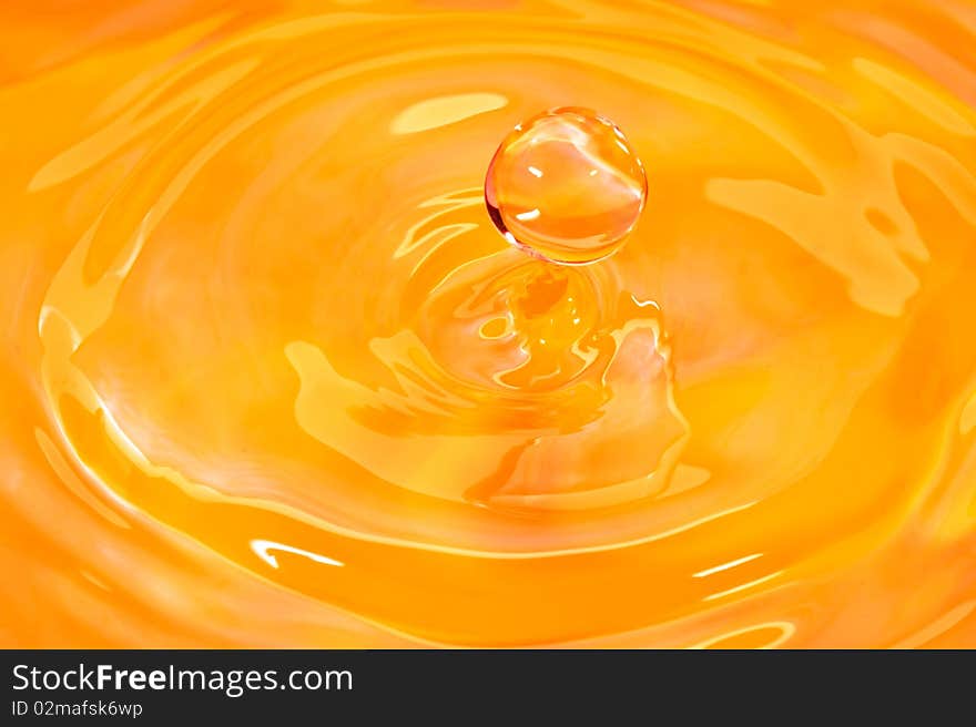 Drop of water seems like a face with the shape. Composed on a orange coloured background. Drop of water seems like a face with the shape. Composed on a orange coloured background.