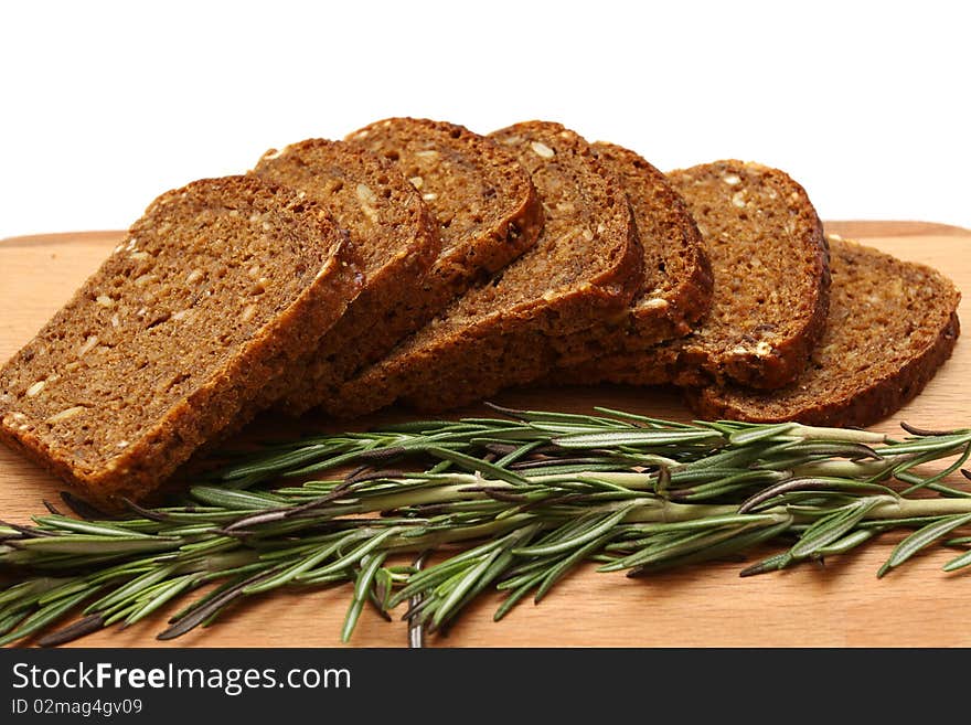 Rosemarine, cut bread and wooden board isolated on a white backgroud. Rosemarine, cut bread and wooden board isolated on a white backgroud