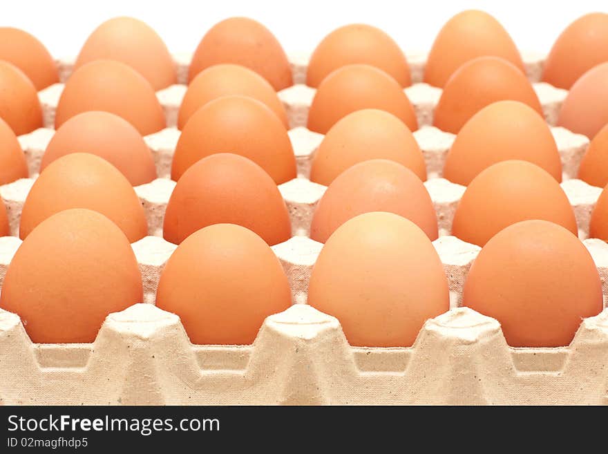 Rows of brown eggs in a protective container