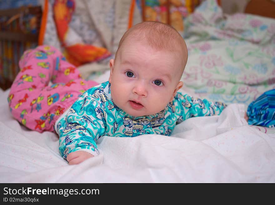 Photo of the beautiful baby lying on bed