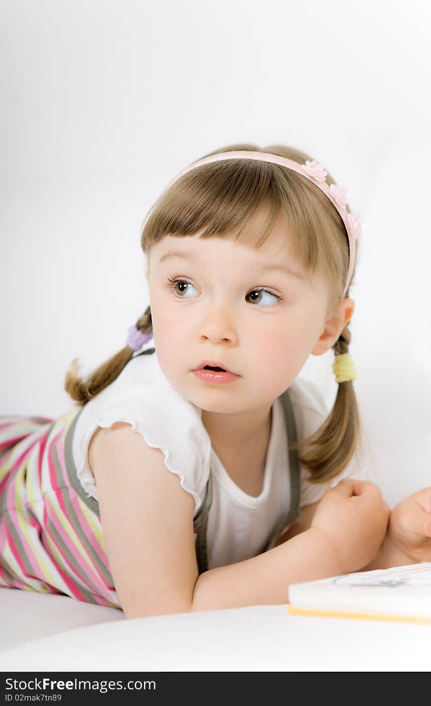 Sweet happy little girl reading book