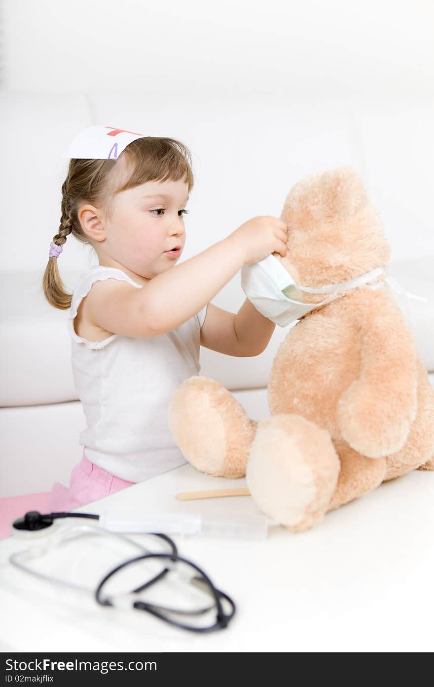 Sweet little girl doctor with teddy bear