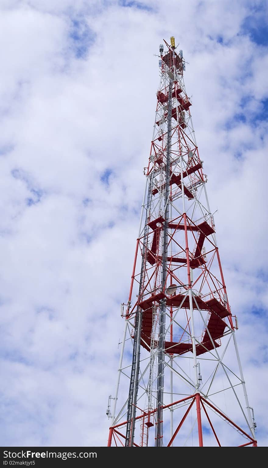 Tall red broadcasting on different frequencies antenna used for wireless telecommunication. Tall red broadcasting on different frequencies antenna used for wireless telecommunication