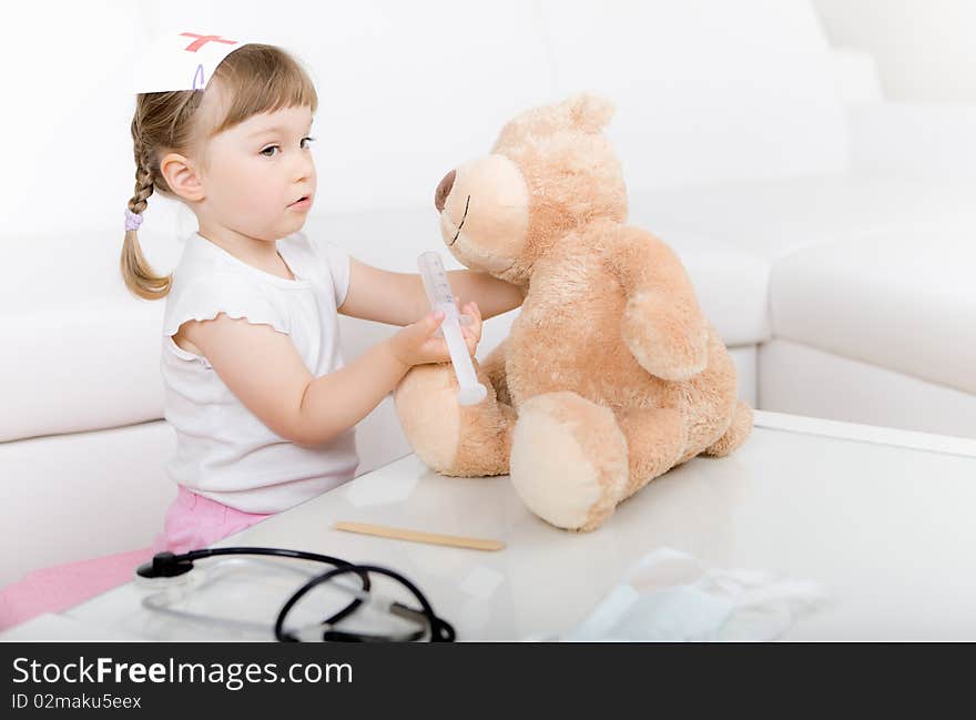 Sweet little girl doctor with teddy bear