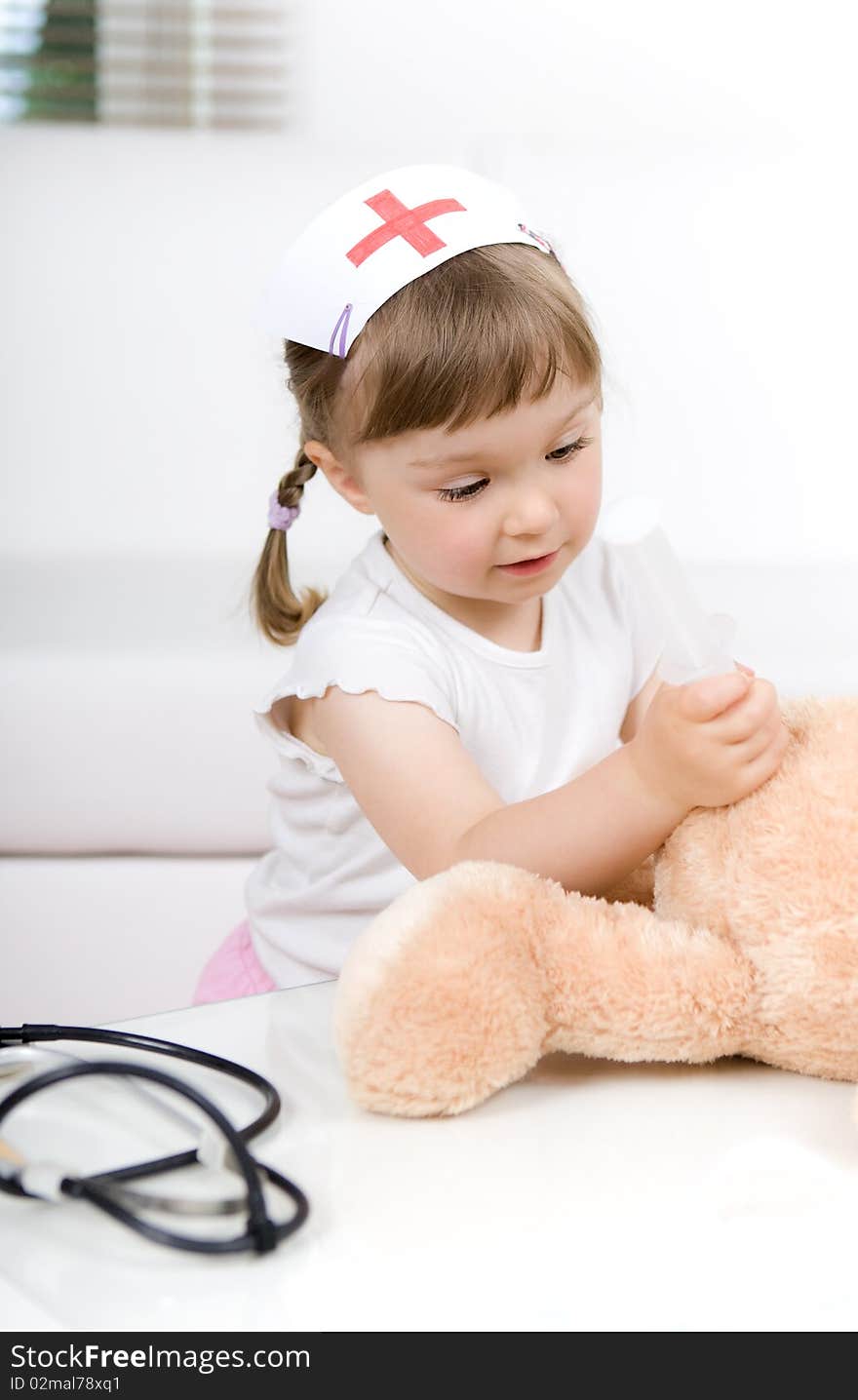 Sweet little girl doctor with teddy bear