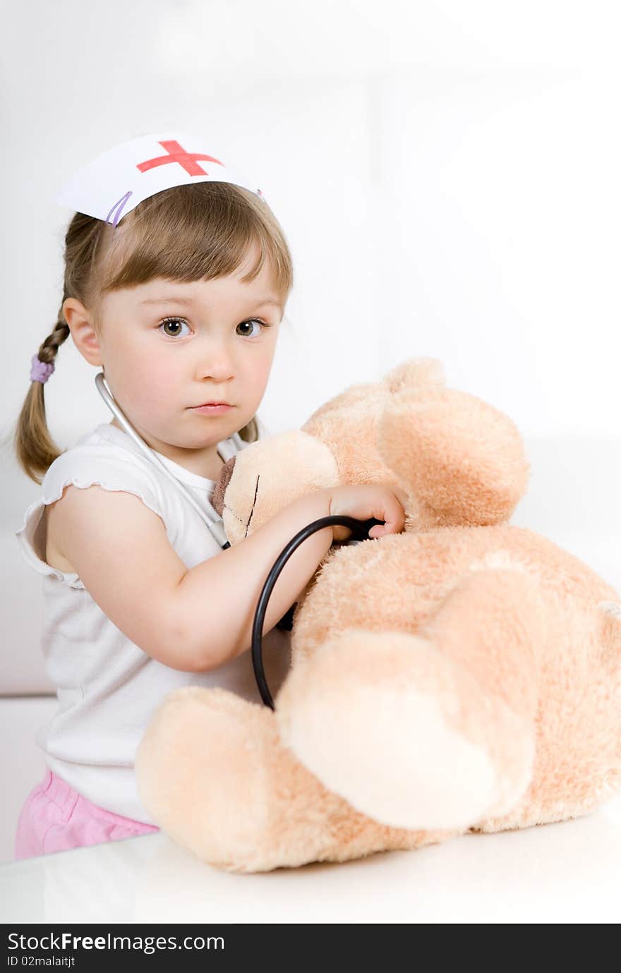 Sweet little girl doctor with teddy bear