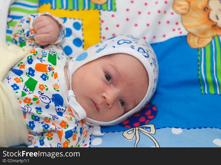 Photo of the beautiful baby lying on bed