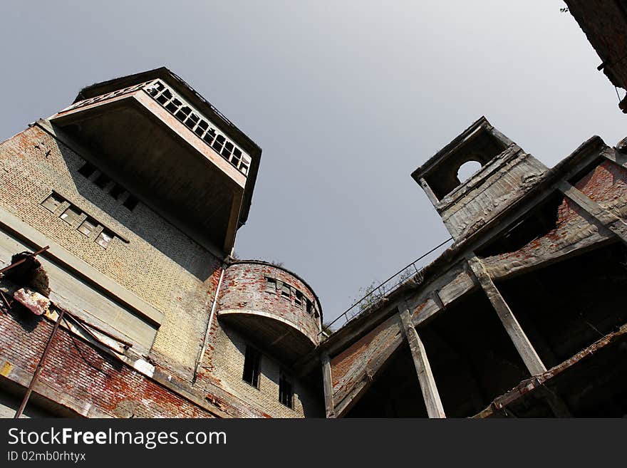 Old and abandoned factory with gray sky above