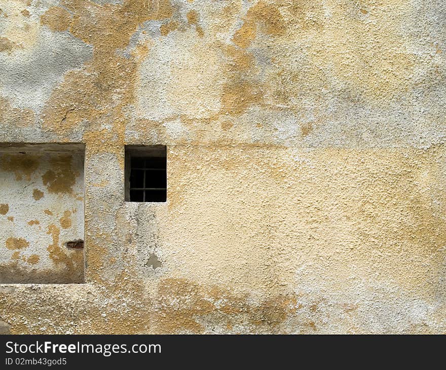 Old wall plastered background with small guarded window. Old wall plastered background with small guarded window.