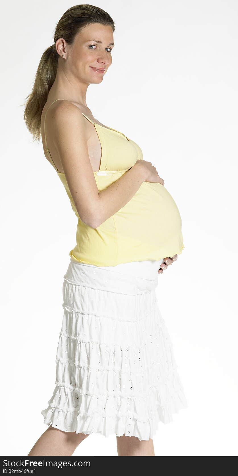 Standing pregnant woman holding her belly