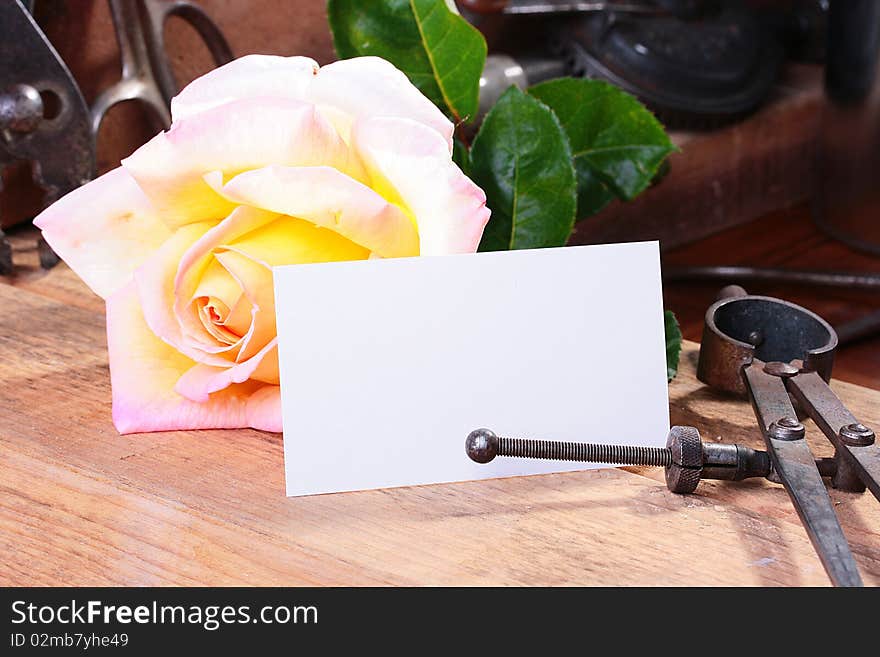 Business card for placing of the text against a rose in a metalwork workshop.