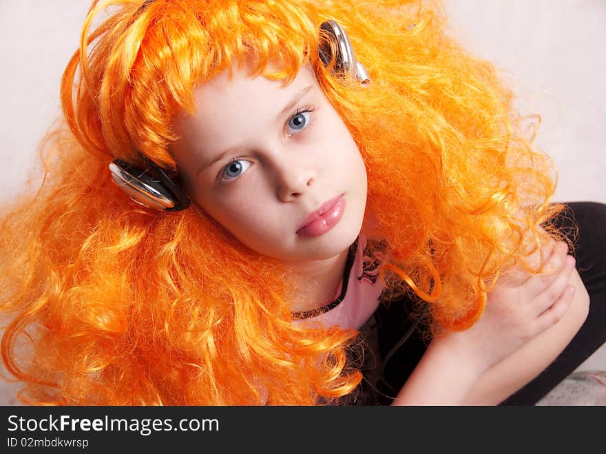 Beautiful little redheaded girl / child listening to disco music with headphones against white background, closeup studio portrait. Beautiful little redheaded girl / child listening to disco music with headphones against white background, closeup studio portrait