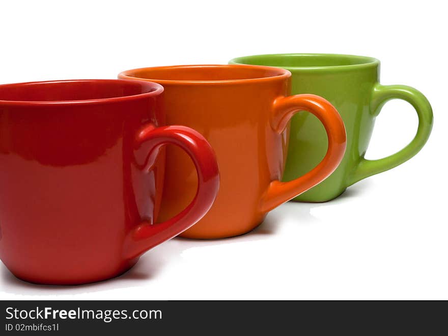 Three cups of different colors, arranged in a row.