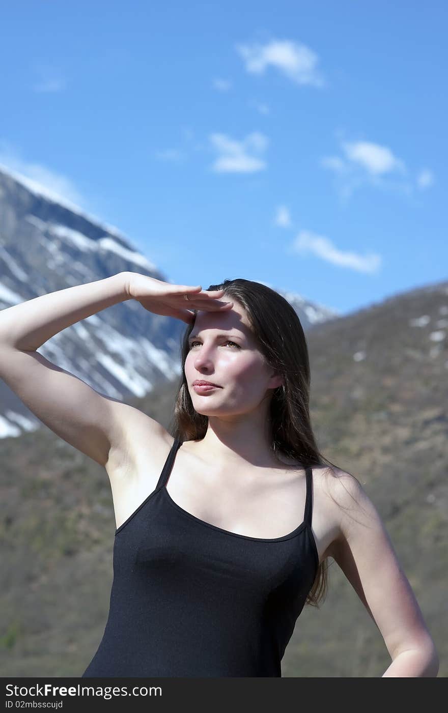 Woman hiker looks to the peak. Woman hiker looks to the peak