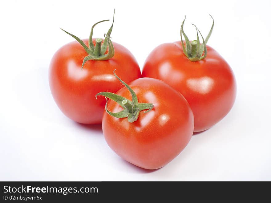 Three red tomato isolated on white background. Three red tomato isolated on white background