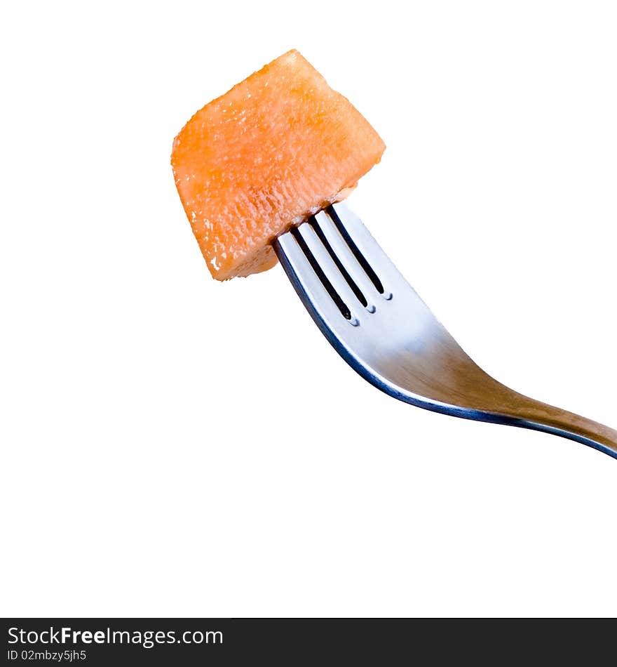 Fresh melon and a fork isolated on a white background.