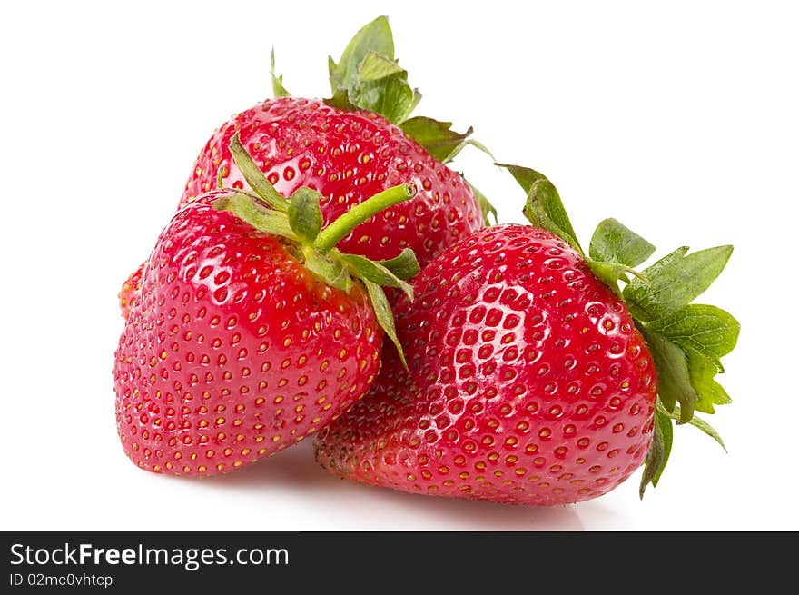 Three strawberries macro shot isolated over white background