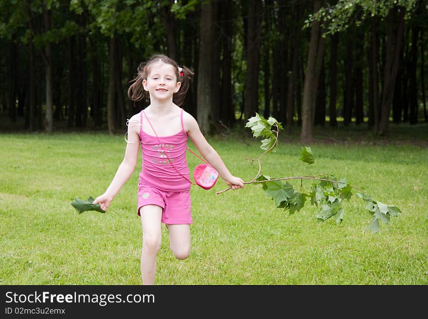 Little girl running in a park in summer. Little girl running in a park in summer.