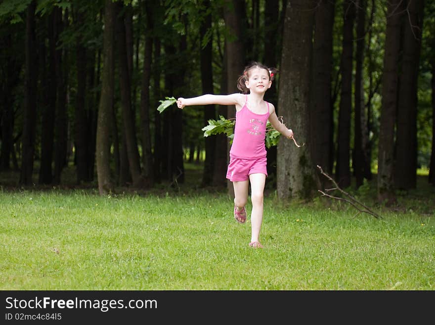 Little girl running in a park in summer. Little girl running in a park in summer.