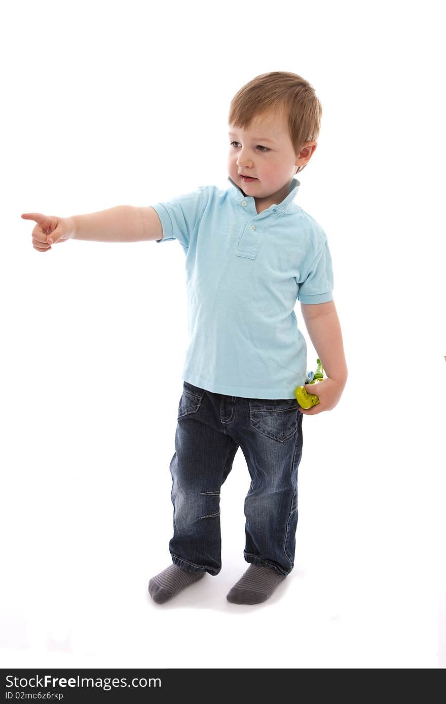 Boy pointing with toy in hand on white background. Boy pointing with toy in hand on white background