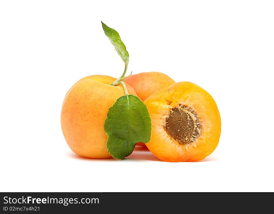 Apricots with leaves on a white background