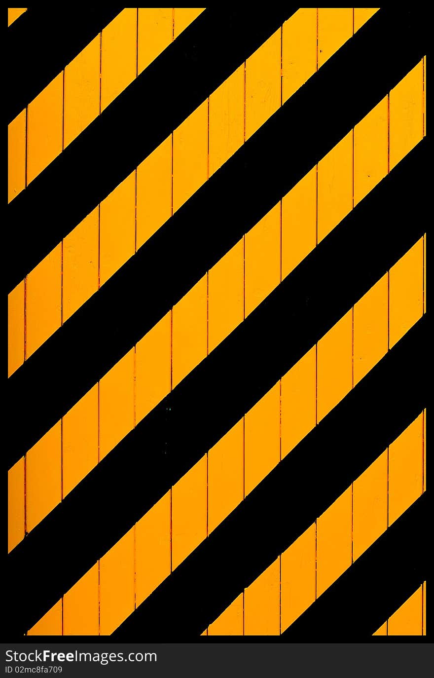 An old engine shed door with striking black and yellow stripes. An old engine shed door with striking black and yellow stripes.