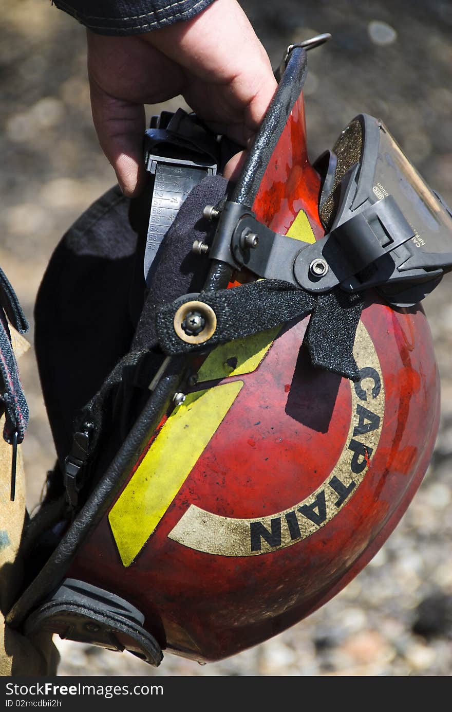 A fire captain carries his helmet during a training exercise. A fire captain carries his helmet during a training exercise.