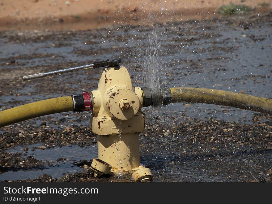 Water leaks from a hose connection during a fire training exercise. Water leaks from a hose connection during a fire training exercise.