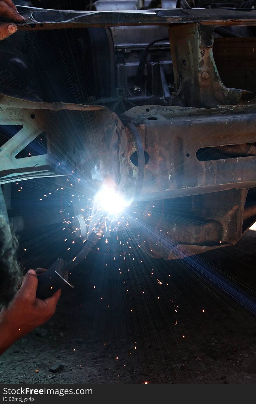 Welding metal smoke sparks in the course of repair the car. Welding metal smoke sparks in the course of repair the car