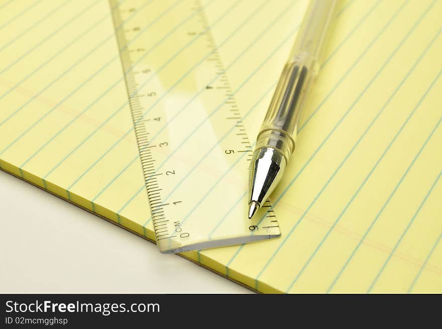 Pen and ruler on a notebook