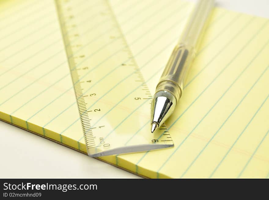 Pen and ruler on a notebook