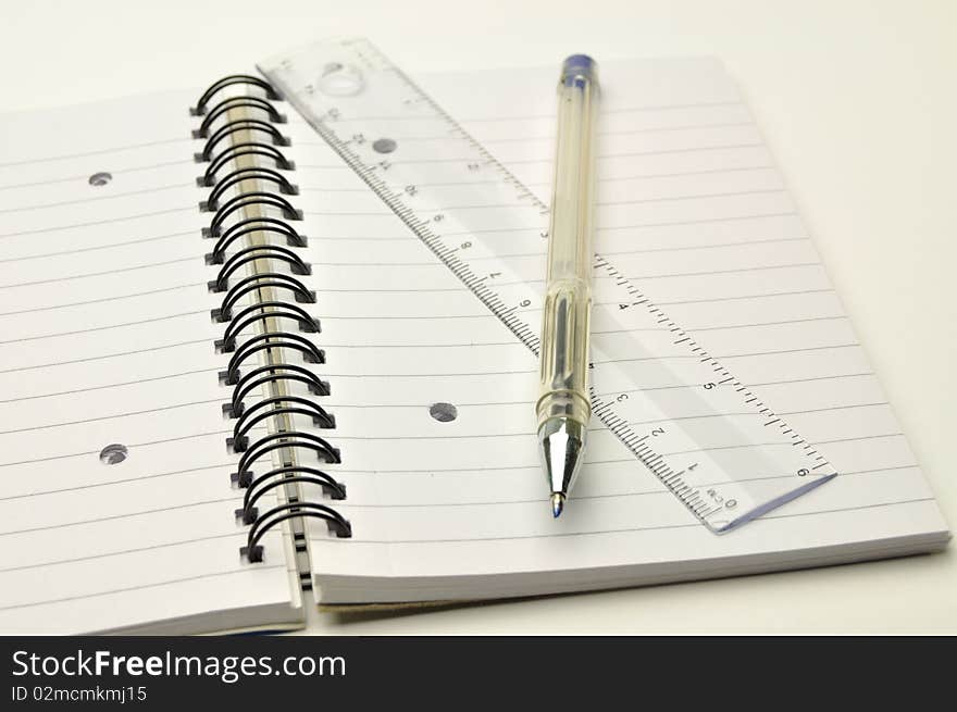 Pen and ruler on a notebook