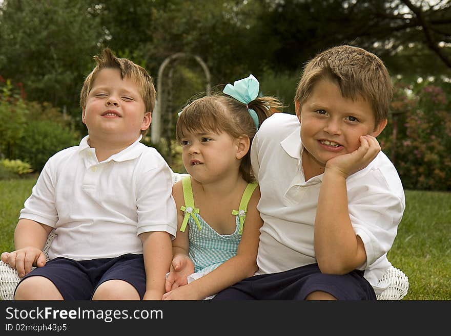 Two brothers and their sister hanging out together outdoors. Two brothers and their sister hanging out together outdoors