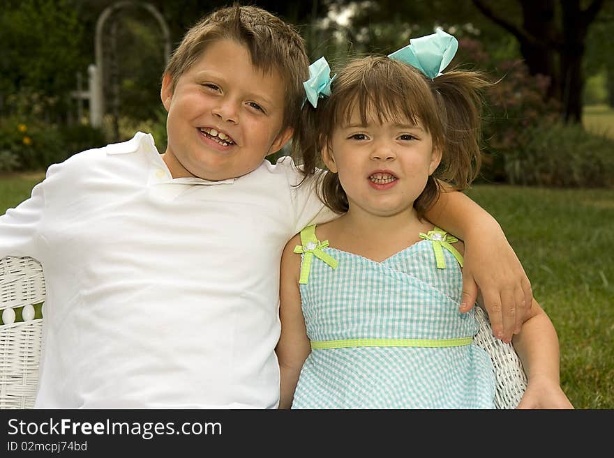 Smiling brother and sister outdoors.