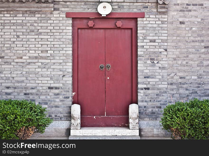 Red door in hutong area, close to Forbidden City, Beijing, China