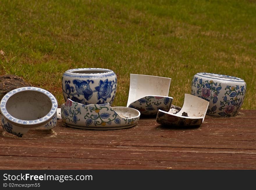 An array of broken planter pots on a deck. An array of broken planter pots on a deck