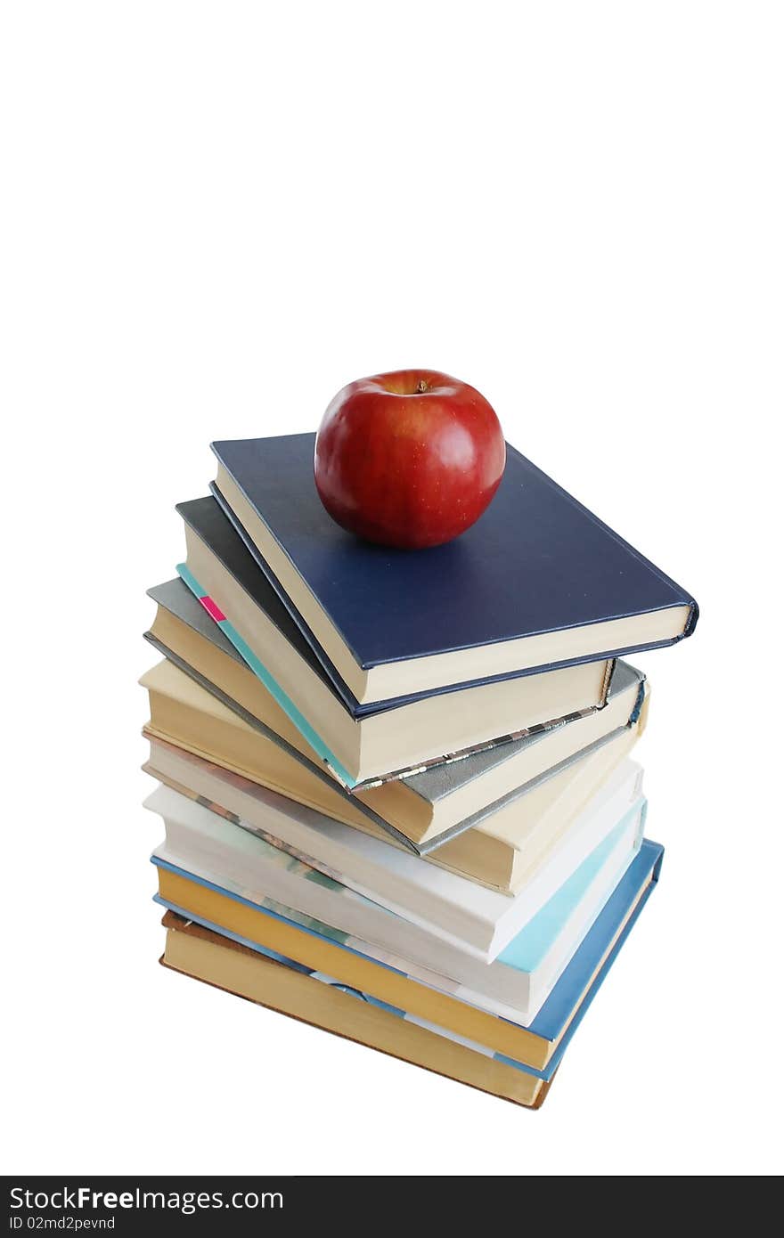 Stack of books with red apple isolated on the white background