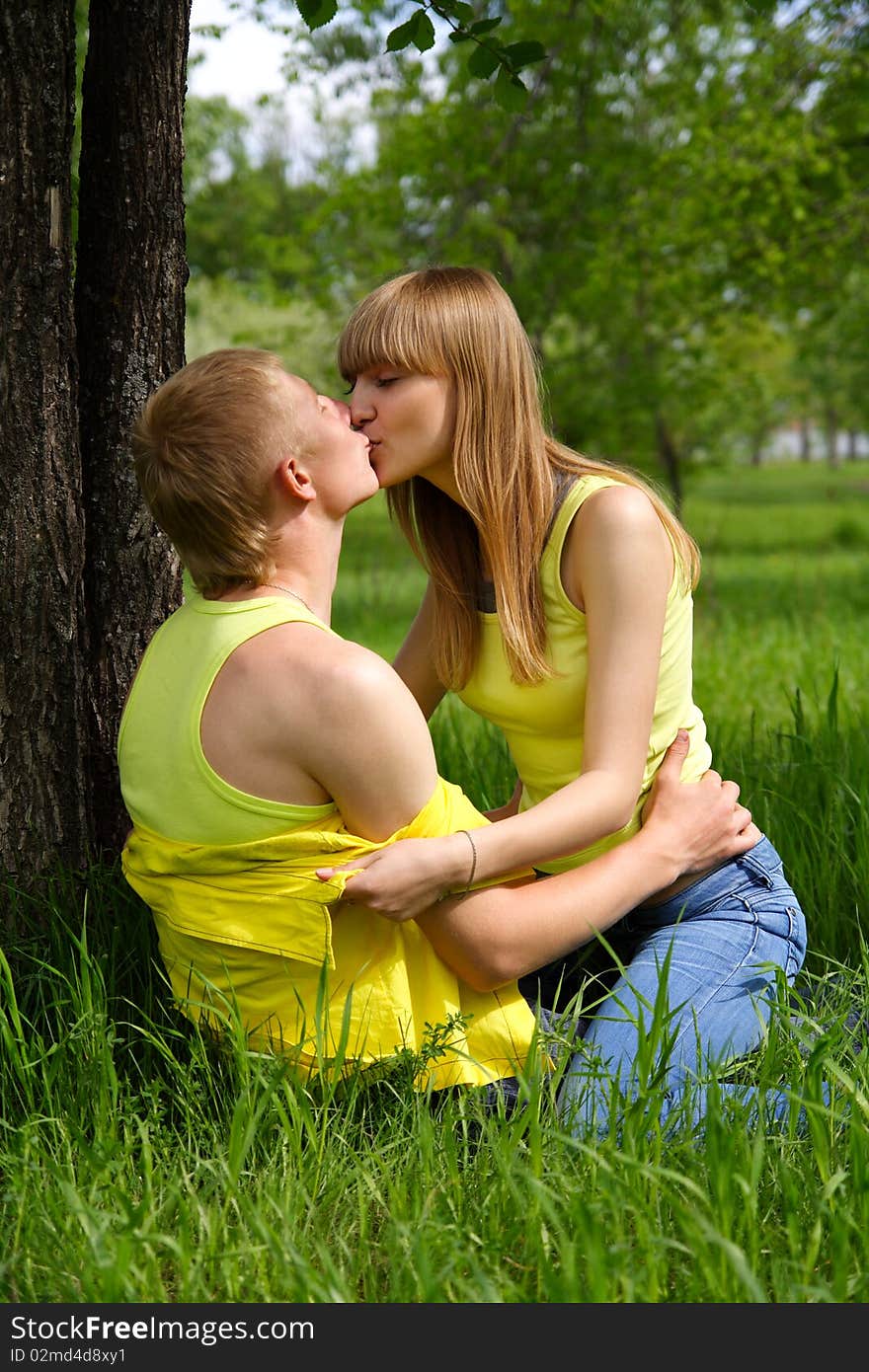 Young guy and the girl kiss in park. Young guy and the girl kiss in park