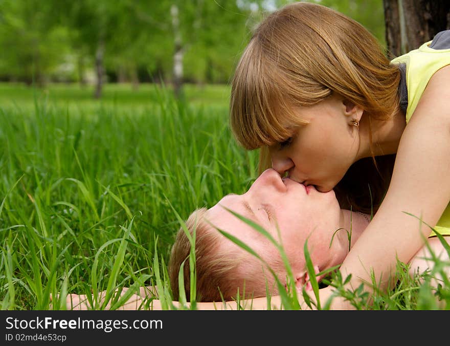 young guy and the girl kiss in park. young guy and the girl kiss in park