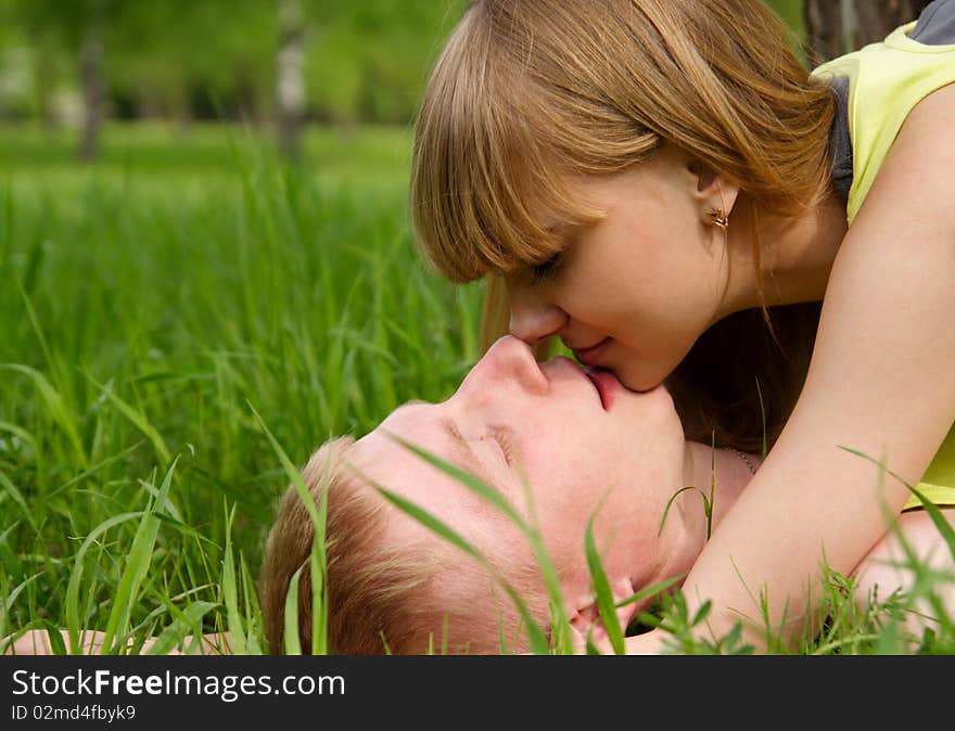 Young beautiful woman and the man lay on a grass. Young beautiful woman and the man lay on a grass