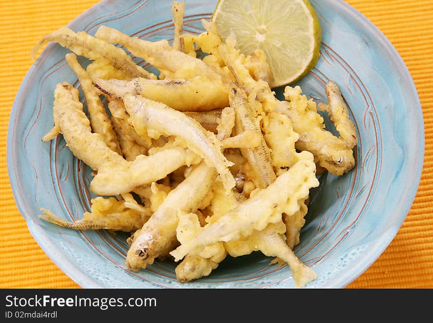 Delicious fresh fried fish on plate with lemon. Delicious fresh fried fish on plate with lemon