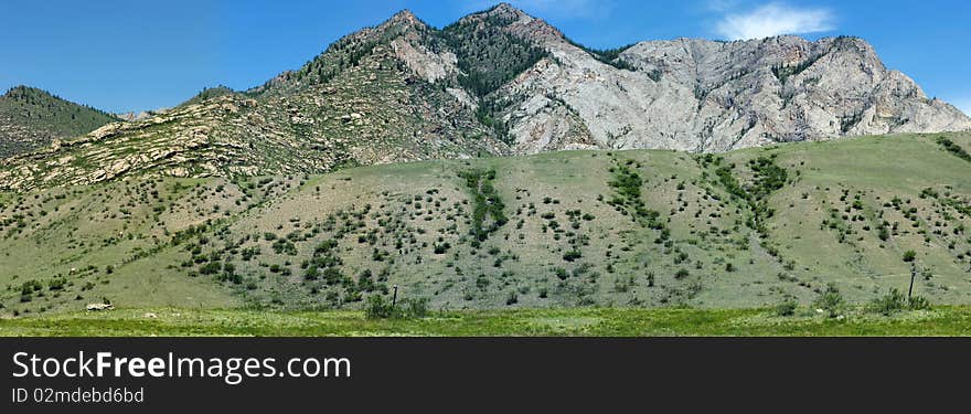 The mountain river flows among vegetation. The mountain river flows among vegetation